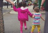 TEACHING A CHILD TO WALK.